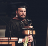 Lee Benson, faculty of the year, supports the university mace at Union's August graduation ceremony. - Photo by Jim Veneman