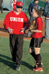 Union head coach Brian Dunn talks with senior left fielder Allison Shein between innings during a Union softball game. - Photo by Amanda Herron