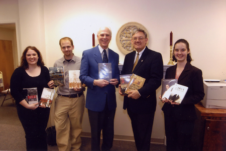 Phi Alpha Theta presidents (past - Spencer Lowery, left of center; present - Heather Tobe, far right; future - Cassie Harris, far left), along with Chapter Advisor Stephen Carls (center) and Library Director Steve Baker, hold history books purchased with prize money that Union's chapter won in a national organization's 2004 Best Chapter Award competition. A check was presented to the library that same day.