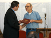 Charles Fowler (left), senior vice president for university relations, presents Jerry Hughes with his diploma in a recent graduation ceremony at the Turney Center prison.  - Photo by Tim Ellsworth