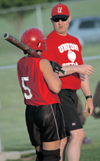 Coach Dunn discusses hitting techniques before Candace Cross’ at-bat. - Photo by Jonathan Blair