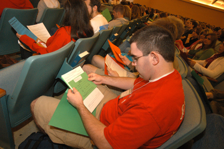 An incoming freshman looks over a collection of registration forms during the Spring Thing weekend.