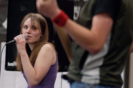 Bess Perrier, lead singer of Bellwether, watches bassist Matthew Diggs perform a solo during their set at the Battle of the Bands event hosted by the Freshman Council to support Relay for Life.
