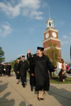 Theatre graduate Lindsey Young waves to a friend during the processional at spring graduation. - Photo by Jim Veneman
