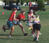 Tie Dyed Michelle Pierce and Lindy Wilson attempt to allude Chi Omega Sophomores Ruth Schroder and Abby Brooks during a Women's Intramural Flag Football game.
 - Photo by Justin Veneman