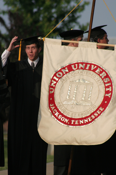 SGA President Brad Spencer leads the faculty processional at spring graduation.
