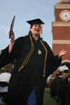 Pychology and sociology graduate Alisha Reeves celebrates after receiving her degree at spring graduation.  Alisha is the first member of her family to graduate from college.  - Photo by Kyle Kurlick