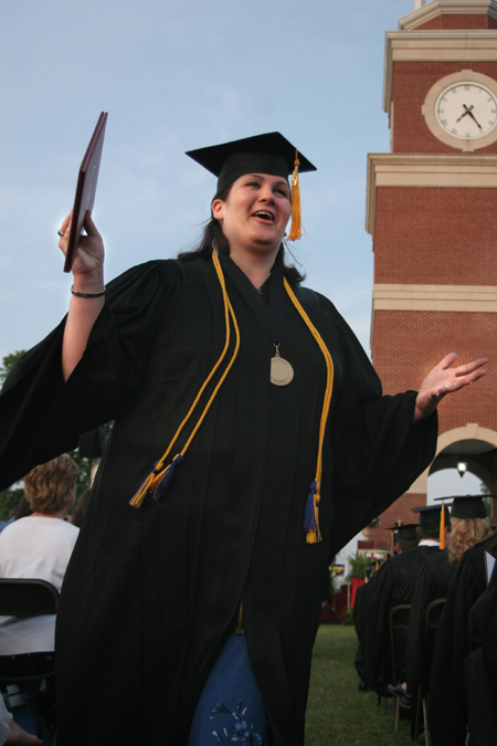 Pychology and sociology graduate Alisha Reeves celebrates after receiving her degree at spring graduation.  Alisha is the first member of her family to graduate from college. 