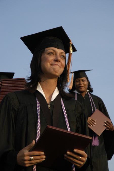Nursing graduates Sarah Anderson and Tina Baker make their way across the stage at spring graduation.