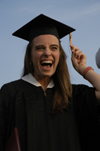 Nursing graduate Rachel Wood struggles with her tassle after receiving her diploma duirng spring graduation. - Photo by Kathleen Murray