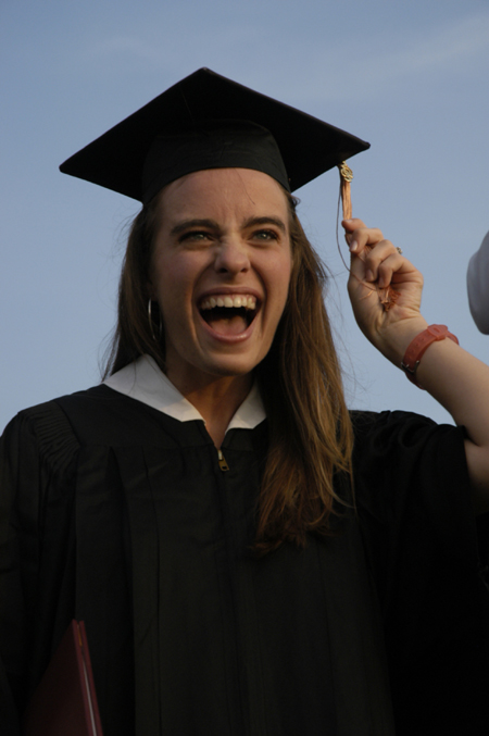 Nursing graduate Rachel Wood struggles with her tassle after receiving her diploma duirng spring graduation.