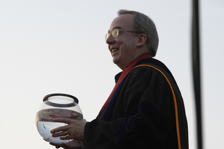 President Dockery holds on to the miniature version of the aquarium presented by the senior class that is to be housed in White Hall. 