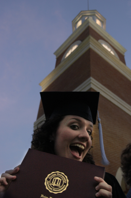 Broacasting graduate Ashley Mitchell shows off her diploma shortly after the spring graduation ceremony.