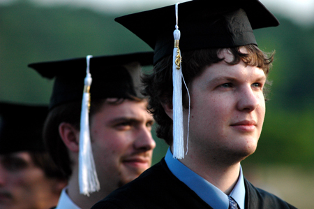 Public relations graduate Ross Kyzar (foreground) and music graduate Chris Lyles (background) look toward the future during spring graduation.