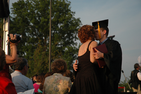 A graduate gets a special recognition after receiving his diploma at spring graduation.