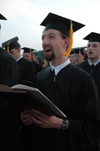 Biology graduate Michael Kieffer joins his fellow graduates in singing the alma mater as alum for the first time at the end of spring graduation. - Photo by Kristen Nicole Sayres