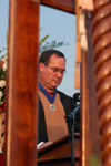 Keith Absher, dean of the McAfee school of business administration, reads the names of the graduates from his school during spring graduation. - Photo by Morris Abernathy
