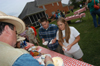 Keith and Beverly Absher dip out cool treats for graduating seniors John Alsobrook and Nichole David during the Happy Trails social at the Dockery's. - Photo by Morris Abernathy