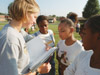 Assignment: Backyard Bible Clubs - Management major Cindy Harrell quizzes students on memory verses, which they memorize in order to ultimately attend an end-of-the-year party. - Photo by Kristen Hiller