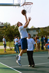 Resident Director Bobby Ludwig goes up for a layup during the Faculty/Staff vs. Student game at the dedication of the Class of 2002 Basketball Court. - Photo by Justin Veneman