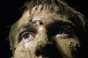 Junior Tony Winkler shows off his accumulation of mud during the Young Alums' Midnight Mudness. - Photo by Kathleen Murray