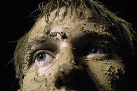 Junior Tony Winkler shows off his accumulation of mud during the Young Alums' Midnight Mudness.