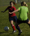 Intramural Soccer Action - Chi Omega Mary Ellen Vaughn tries to pass Sniper Beth McDowell. - Photo by Jonathan Blair