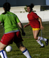 Intramural Soccer Action - Chi Omega Gina Orosz keeps her eyes on goal. - Photo by Jonathan Blair
