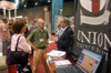 Union President David S. Dockery talks to Jonathan Newman ('90) and his wife Jeni at the Union booth during the Southern Baptist Convention. - Photo by Brad Moore