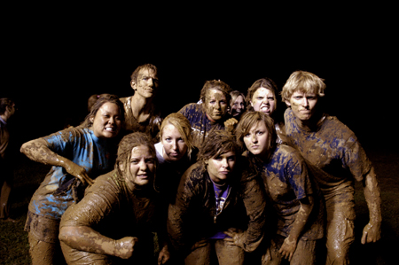 The winning team from Midnight Mudness 2005 flexes their mud muscles. Pictured from left to right: Kari Mynatt, Jennifer Winfield, Tony Winkler, Emily Kuhnert, Whitney Culver, Lindsay Grace Brown, Brittany Stephens,Bethany Little, Jennifer Hanes and Nathan Michael.