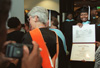 Tabitha Freeman, who has just received her Master of Education degree during Union Universty's August graduation, shows her diploma to family and friends. - Photo by Jim Veneman