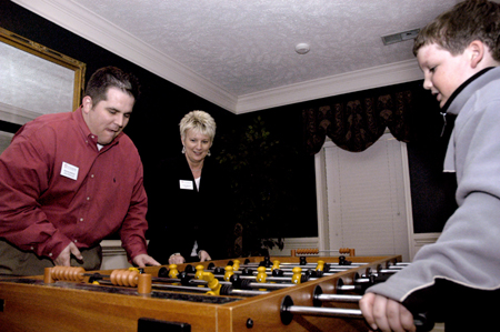 Advancement Officers Cristian Murdock and Katrina Bradfield enjoy a foosball game during the Homecoming 2005 reunions.