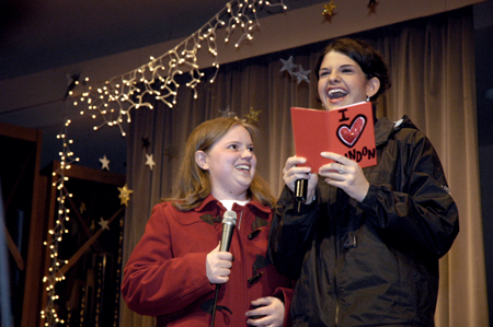 Seniors Becky Johnson and Jodie Curtis read a card about fellow Union student Landon Preston while hosting the Variety Show.