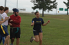 Rob Krauss and Keith Varden keep their eyes on the turkey being advanced up the field by Virginia (Gina) Orosz during the Young Alums' Turkey Bowl. - Photo by Kristen Hiller