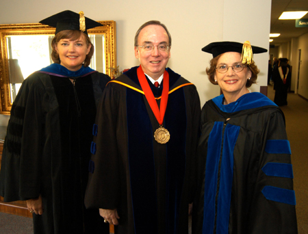 Provost Carla Sanderson and President David S. Dockery pose with summer commencement speaker Carolyn G. Bishop, president for the Consortium for Global Education.