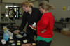 Senior Emily Brown and Sophomore April Wright take a look at the items for sale at the Annual Christmas Pottery Sale. - Photo by Amanda Herron