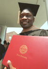 Elvis Ochieng holds his Master of Business Administration diploma received moments earlier during Union University's August graduation. - Photo by Jim Veneman