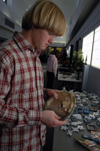 Freshman Ben Rivers examines a piece of pottery at the Annual Christmas Pottery Sale. - Photo by Amanda Herron