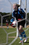 Freshman Jennifer Hollis prepares to pass the ball after she makes the save.
 - Photo by Kathleen Murray