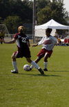 Cynthia Medina, sophomore, makes a move on a Freed-Hardeman defender during Union's scrimmage. - Photo by Kathleen Murray