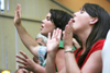Tiffany Fredericks (left) and her mother Cindi (right) of Delmar, N.Y. participate in the worship service during New Student Orientation. - Photo by Kyle Kurlick