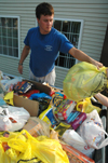 Senior Brett Logan assists in sorting goods donated to Hurricane Katrina victims.  Union students left bags on doorsteps over Labor Day weekend throughout Jackson and collected them, sorted them into different categories between Hurt and Watters Commons, then delivered them to West Jackson Baptist Church. - Photo by Brad Moore