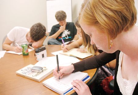 Julie Laugherty, one of the founders of ink., takes part in a writing challenge at the first meeting. Attendees were challenged to write a poem or short story paragraph incorporating the words “run,” “ask” and “radish.”