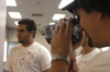 Sophomore Aaron Hardin shoots footage for the season's third episode of <i>uBuzz</i> as Ryan Sidhom tries to recruit a new member the fictitious fraternity <i>Upsilon Beta Zeta.</i> - Photo by Heather Phillips