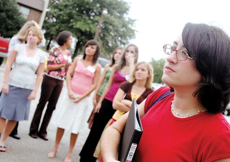 Gamma Rho Chi junior Merry Hindman, biology major,
leads her group of rushees to the Chi Omega lodge for skit night on Sept. 15.  While serving as a Rho Chi, Hindman, along with 13 other girls, was not
allowed to speak to her sorority sisters for a period of five months.