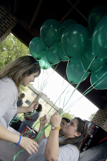Junior Annie Oliver and Senior Karyn Caldwell prepare decorations in the Sugar Shack for Kappa Delta's ice cream social for National Women's Friendship Day.