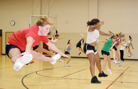 Junior Peaches Hughes, learning foundations
major, and several other girls practice their jumps at cheerleader tryouts.