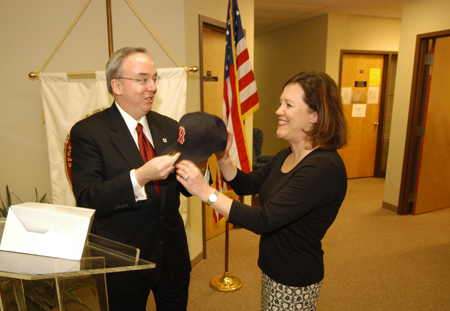 President Dockery congratulates Dr. Kina Mallard on her new position at Gordon College with a Red Sox cap.