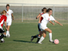 Charity Carter (22) battles a Martin Methodist player for ball possession. - Photo by Steven Aldridge