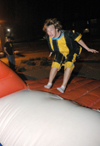 Freshman Dustin Nelson bounces toward the inflatable velcro wall during Fallapalooza. - Photo by Brad Moore
